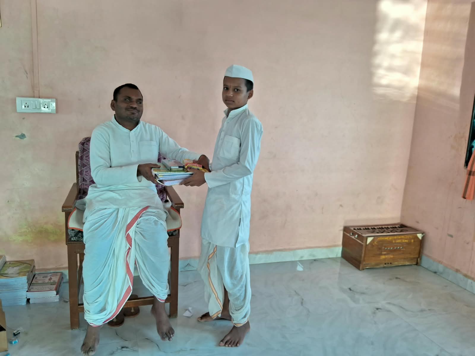 Student receiving a set of books